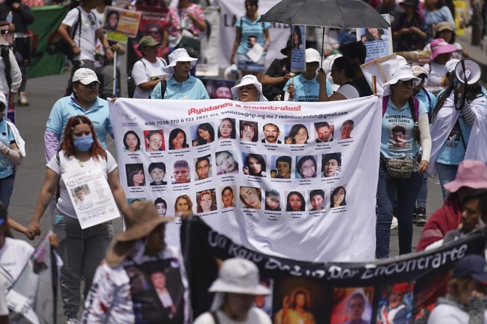 FILE - People attend the annual National March of Searching Mothers, held every Mother's Day in Mexico City, Friday, May 10, 2024. The marchers say the government lacks interest in investigating the disappearances of Mexico's over 100,000 missing people. (AP Photo/Marco Ugarte, File)