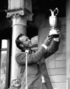 FILE - British Open champion Arnold Palmer poses with his trophy held high for all to see at the presentation ceremonies at Troon, Scotland, July 13, 1962. Palmer was the first American winner at Troon. (AP Photo/File)