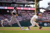 Oakland Athletics' Brent Rooker reaches first for a single past Philadelphia Phillies first baseman Bryce Harper during the fourth inning of a baseball game, Saturday, July 13, 2024, in Philadelphia. (AP Photo/Matt Slocum)