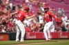 Cincinnati Reds' Jeimer Candelario (3) celebrates with third base coach J.R. House (56) as he rounds the bases after hitting a solo home run during the third inning of a baseball game against the Miami Marlins, Saturday, July 13, 2024, in Cincinnati. (AP Photo/Jeff Dean)