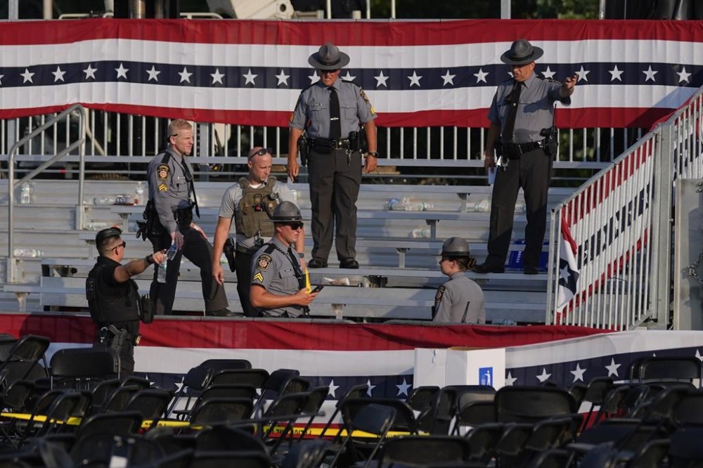 Law enforcement officers gather at the campaign rally site for Republican presidential candidate former President Donald Trump Saturday, July 13, 2024, in Butler, Pa. Trump's campaign said in a statement that the former president was