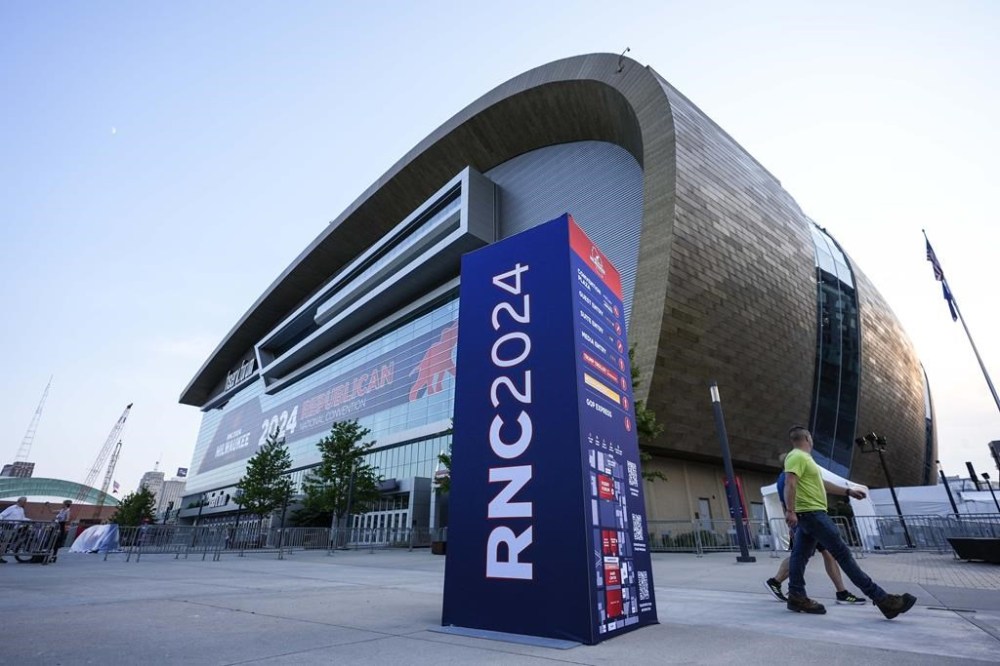 People walk outside the Fiserv Forum ahead of the 2024 Republican National Convention, Saturday, July 13, 2024, in Milwaukee. Donald Trump's campaign said in a statement that the former president was