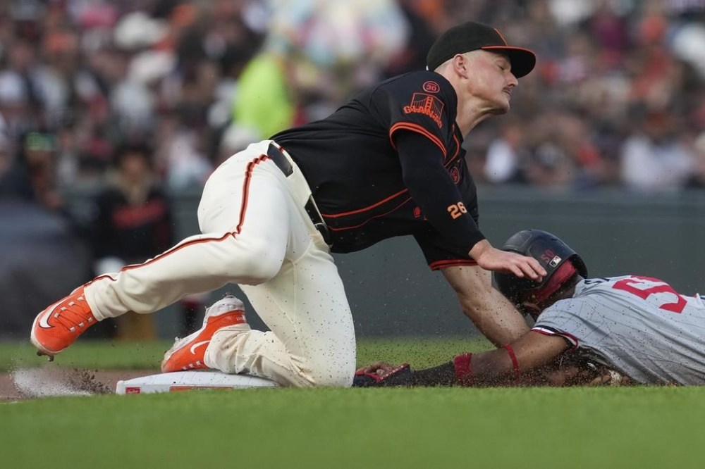 San Francisco Giants third baseman Matt Chapman, left, tags out Minnesota Twins' Willi Castro, right, who was attempting to steal third during the seventh inning of a baseball game Saturday, July 13, 2024, in San Francisco. (AP Photo/Godofredo A. Vásquez)