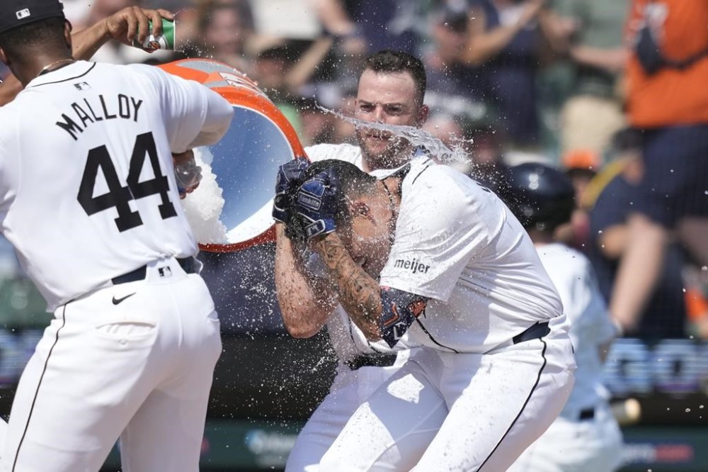 Detroit Tigers' Gio Urshela is doused by Jake Rogers after hitting a two-run home run during the 10th inning of a baseball game against the Los Angeles Dodgers, Saturday, July 13, 2024, in Detroit. (AP Photo/Carlos Osorio)