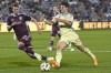 New York Red Bulls forward Dante Vanzeir (13) pursues the ball with Colorado Rapids defender Andreas Maxsø in the second half of an MLS soccer match Saturday, July 13, 2024, in Commerce City, Colo. (AP Photo/David Zalubowski)