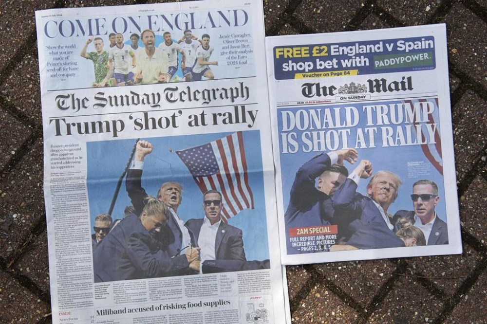 Two front pages of British national newspapers, late editions for London, Sunday, July 14, 2024, showing the reaction to events at former President Trump campaign rally in Butler, Pennsylvania. Donald Trump's campaign says he is