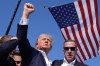Republican presidential candidate former President Donald Trump reacts as he is surrounded by U.S. Secret Service agents at a campaign rally, Saturday, July 13, 2024, in Butler, Pa. The image of Trump pumping his fist into the air with an American flag in the background, as blood trickles down the side of the former president’s face, came at a critical time in an increasingly polarized political climate for the United States. THE CANADIAN PRESS/AP/Evan Vucci