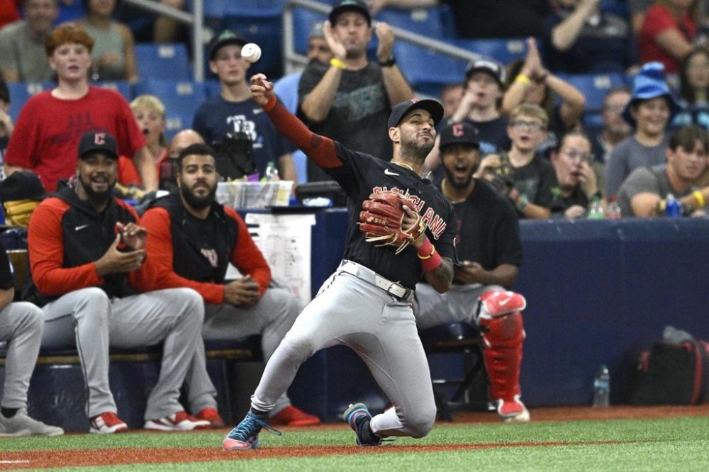 Cleveland Guardians shortstop Brayan Rocchio throws to second base after catching a fly ball in foul territory by Tampa Bay Rays' Isaac Paredes during the eighth inning of a baseball game, Sunday, July 14, 2024, in St. Petersburg, Fla. (AP Photo/Phelan M. Ebenhack)