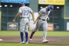 Texas Rangers' Josh Smith, right, celebrates his two-run home run against the Houston Astros with third base coach Tony Beasley during the first inning of a baseball game, Sunday, July 14, 2024, in Houston. (AP Photo/Eric Christian Smith)