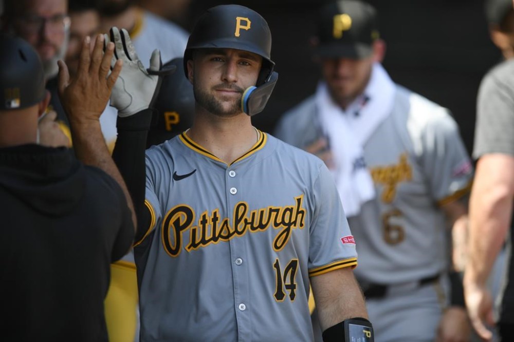 Pittsburgh Pirates' Joey Bart (14) celebrates with teammates in the dugout after hitting a three-run home run during the fourth inning of a baseball game against the Chicago White Sox, Sunday, July 14, 2024, in Chicago. (AP Photo/Paul Beaty)