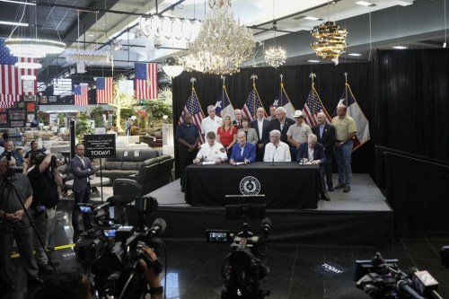 Gov. Greg Abbott, sitting second from left, holds a press conference on the response and recovery efforts after Hurricane Beryl, Sunday, July 14, 2024, at Gallery Furniture in Houston. Abbott was joined by Texas Division of Emergency Management Chief Nim Kidd, from sitting left, Lt. Gov. Dan Patrick and Gallery Furniture Owner Jim 