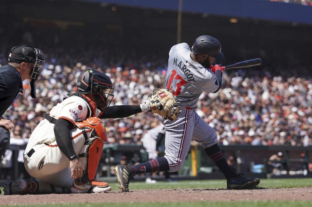 Minnesota Twins' Manuel Margot hits a double against the San Francisco Giants during the ninth inning of a baseball game in San Francisco, Sunday, July 14, 2024. (AP Photo/Kavin Mistry)