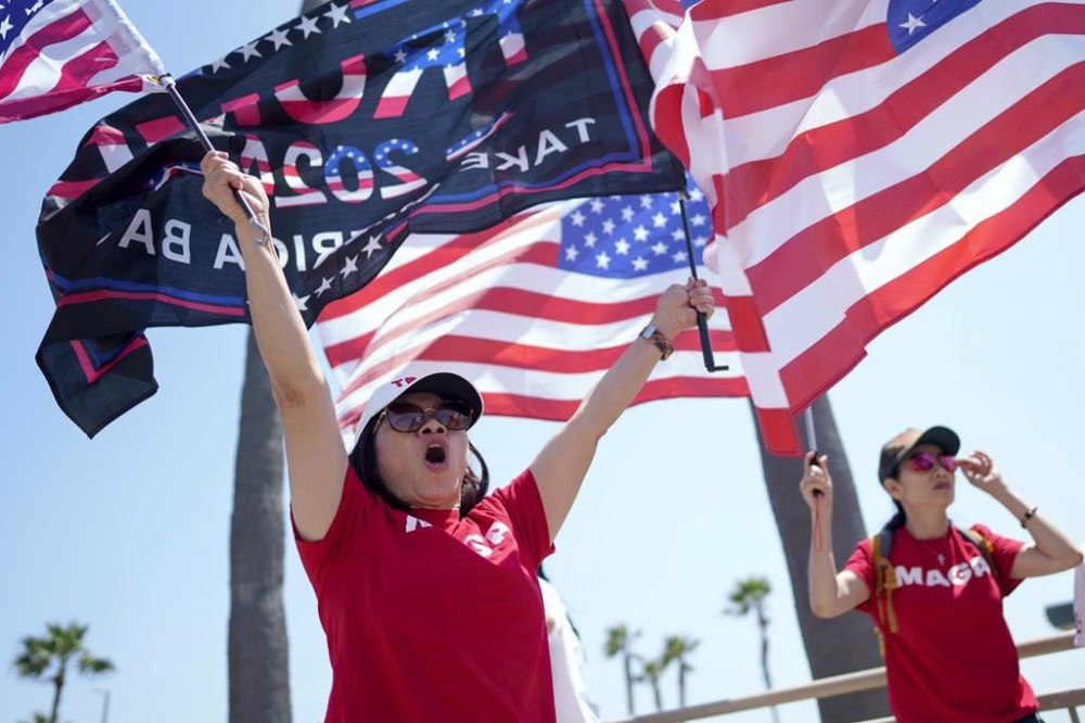 People rally in support of former President and Republican presidential candidate Donald Trump in Huntington Beach, Calif., Sunday, July 14, 2024. (AP Photo/Eric Thayer)