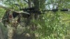 In this photo taken from video released by the Russian Defense Ministry on Sunday, July 14, 2024, a Russian sniper prepares to shoot toward Ukrainian position in an undisclosed location in Ukraine. (Russian Defense Ministry Press Service via AP)