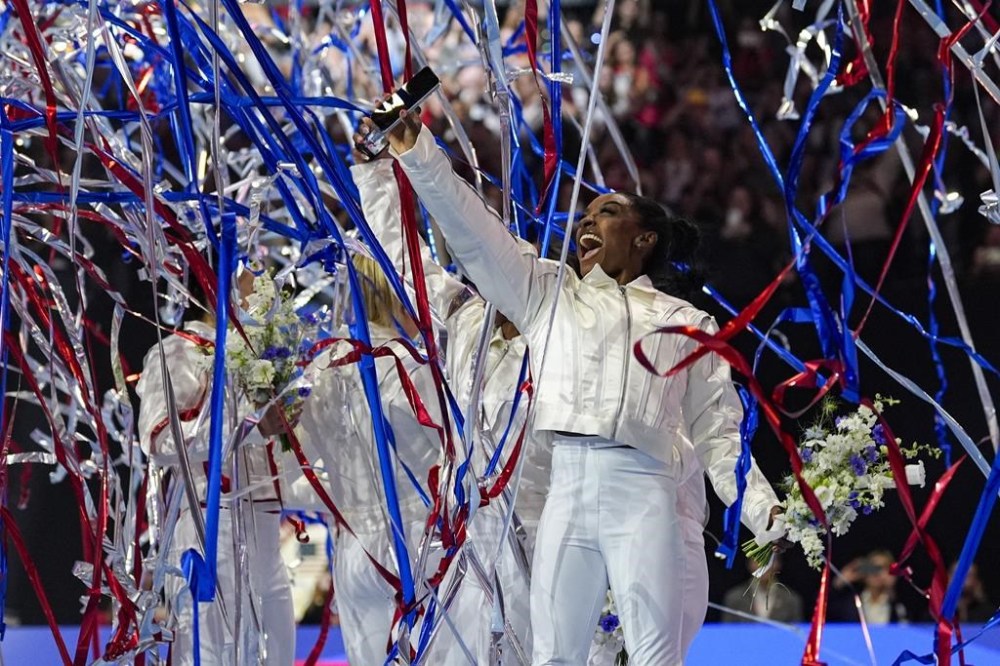FILE - Simone Biles and the U.S. women celebrate as the 2024 team is named at the United States Gymnastics Olympic Trials on Sunday, June 30, 2024, in Minneapolis. (AP Photo/Abbie Parr, File)