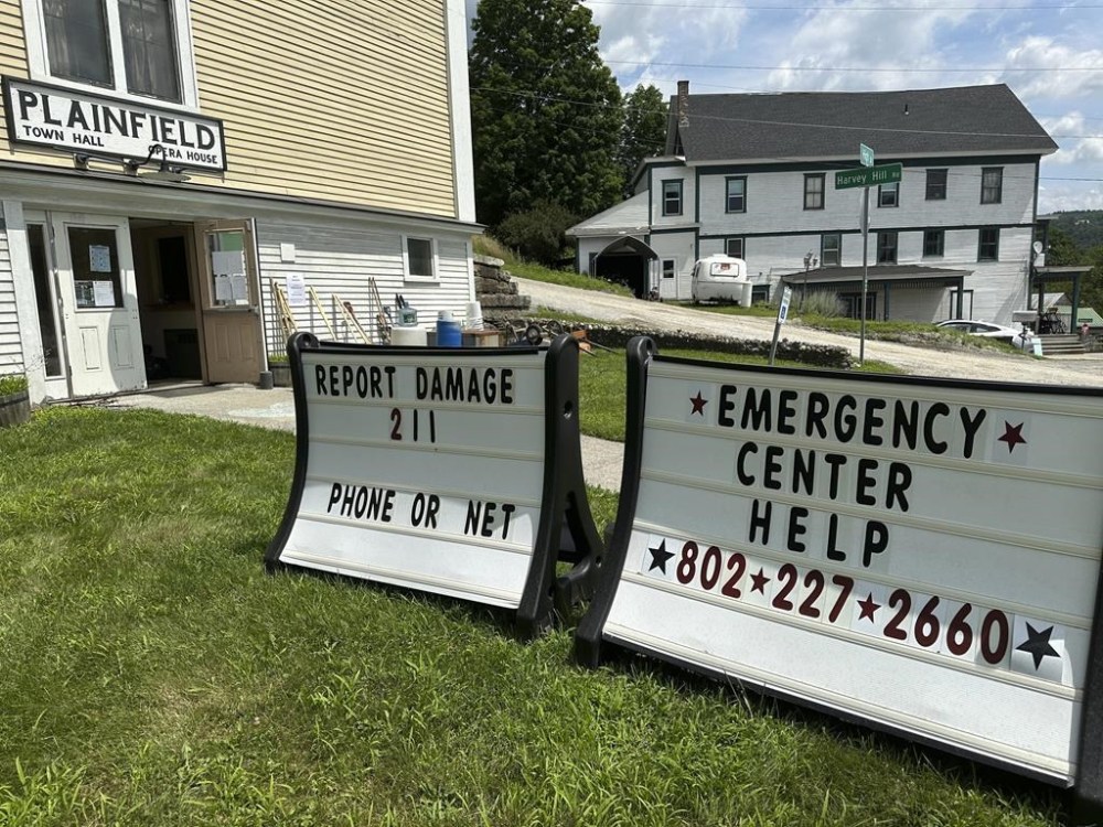 Signs are displayed outside the town hall, Sunday, July 14, 2024, in Plainfield, Vt., a community that had some of the worst damage in last week's flooding. (AP Photo/Lisa Rathke)