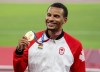Andre De Grasse of Canada shows off his gold medal for the men’s 200m at the Tokyo Olympics in Tokyo, Japan on August 5, 2021. THE CANADIAN PRESS/ Frank Gunn