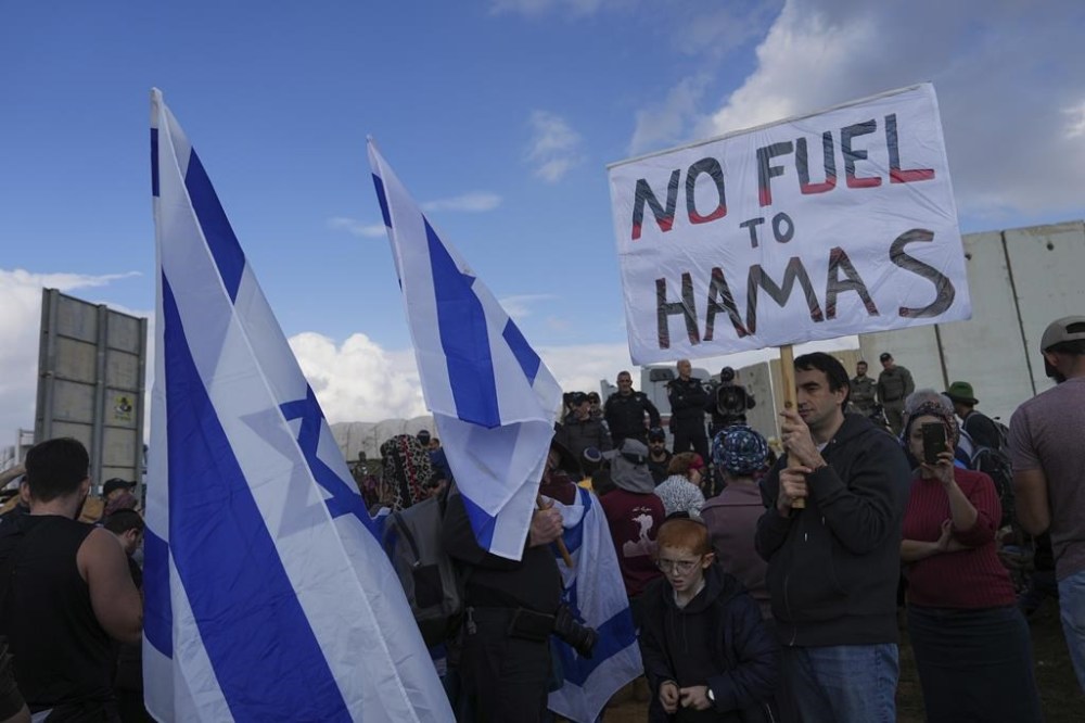 FILE - Israeli police prevent activists from blocking trucks carrying humanitarian aid into the Gaza Strip at the Kerem Shalom border crossing, southern Israel, Monday, Jan. 29, 2024. (AP Photo/Tsafrir Abayov, File)