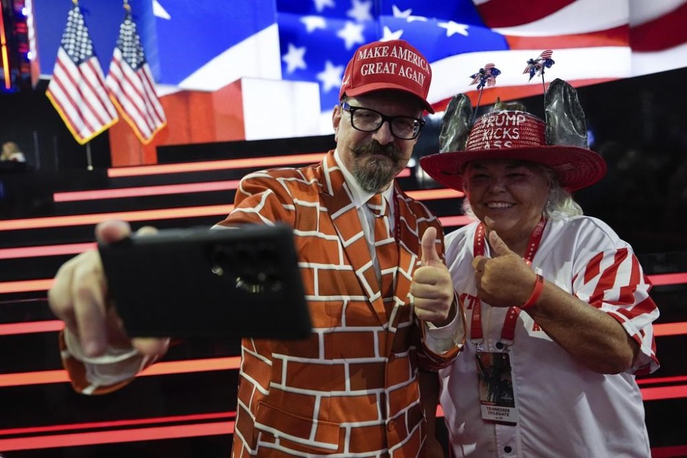 Delegates take selfies on the convention floor during the Republican National Convention Monday, July 15, 2024, in Milwaukee. (AP Photo/Julia Nikhinson)