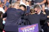 Republican presidential candidate former President Donald Trump is surrounded by U.S. Secret Service at a campaign event in Butler, Pa., on Saturday, July 13, 2024. (AP Photo/Gene J. Puskar)
