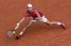 FILE - Serbia's Novak Djokovic plays a shot against Argentina's Francisco Cerundolo during their fourth-round match of the French Open tennis tournament at the Roland Garros stadium in Paris, June 3, 2024. For the first time in more than 30 years, the tennis competition at an Olympics will be held on red clay, which means players who just made the adjustment from that surface at the French Open in early June to grass at Wimbledon in early July now will need to reverse course again in short order. (AP Photo/Thibault Camus, File)