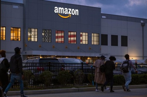 FILE - People arrive for work at the Amazon distribution center in the Staten Island borough of New York, on Oct. 25, 2021. A report released by U.S. Senator Bernie Sanders said Amazon's popular Prime Day sales event has been 