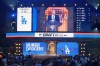 Major League Baseball Commissioner Rob Manfred, at podium, announces the selection made by the Los Angeles Dodgers in the first round of the MLB baseball draft in Fort Worth, Texas, Sunday, July 14, 2024. The Dodgers selected Kellon Lindsey. (AP Photo/LM Otero)