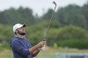 Scottie Scheffler of the United States looks at his club on the practice range ahead of the British Open Golf Championships at Royal Troon golf club in Troon, Scotland, Tuesday, July 16, 2024. (AP Photo/Jon Super)