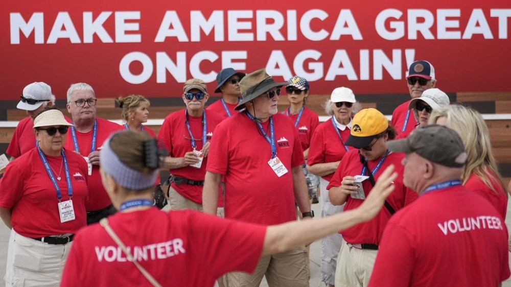 Volunteers gather for a meeting outside the Fiserv Forum during the second day of the 2024 Republican National Convention, Tuesday, July 16, 2024, in Milwaukee. (AP Photo/Jae C. Hong)