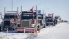 A truck convoy of anti-COVID-19 vaccine mandate demonstrators block the highway at the busy U.S. border crossing in Coutts, Alta., Feb. 2, 2022. THE CANADIAN PRESS/Jeff McIntosh