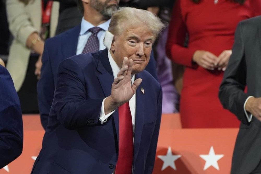 Evan Vucci / Associated Press Files
Days after the shooting Trump appeared at the Republican National Convention in Milwaukee with a small bandage over the wound.