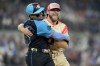 American League starting pitcher Corbin Burnes, of the Baltimore Orioles, right, hugs National League's William Contreras, of the Milwaukee Brewers, after an out on a ground ball by Contreras in the first inning during the MLB All-Star baseball game, Tuesday, July 16, 2024, in Arlington, Texas. (AP Photo/Julio Cortez)