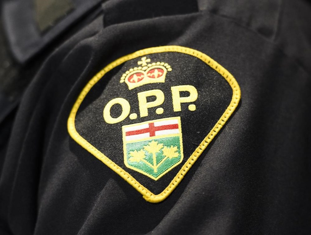 An Ontario Provincial Police logo is shown during a press conference in Barrie, Ont., on April 3, 2019. A teenager who was reported missing on Sunday after going swimming in Lake Erie has been found dead. Ontario Provincial Police say the victim was a 14-year-old from London. THE CANADIAN PRESS/Nathan Denette