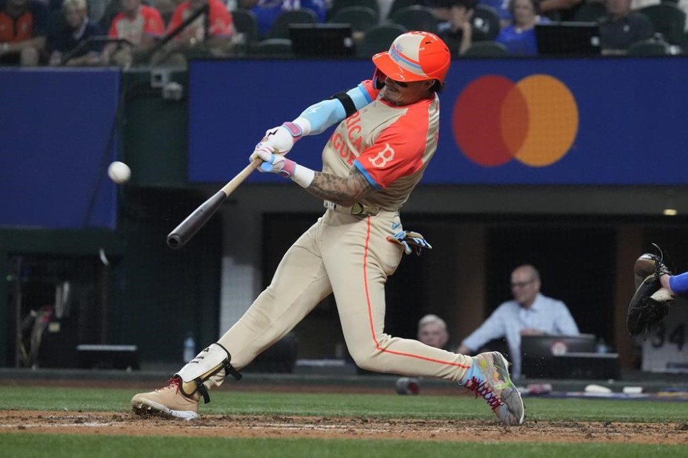 American League's Jarren Duran, of the Boston Red Sox, hits a home run during the fifth inning of the MLB All-Star baseball game, Tuesday, July 16, 2024, in Arlington, Texas. Anthony Santander, of the Baltimore Orioles, also scored. (AP Photo/LM Otero)