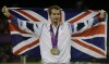 FILE - Andy Murray of Great Britain poses with his gold and silver medals in tennis at the All England Lawn Tennis Club in Wimbledon, London at the 2012 Summer Olympics, Sunday, Aug. 5, 2012. The tennis competition at the Paris Olympics could be where past gold medalists Rafael Nadal and Andy Murray bid adieu to the sport.(AP Photo/Mark Humphrey, File)