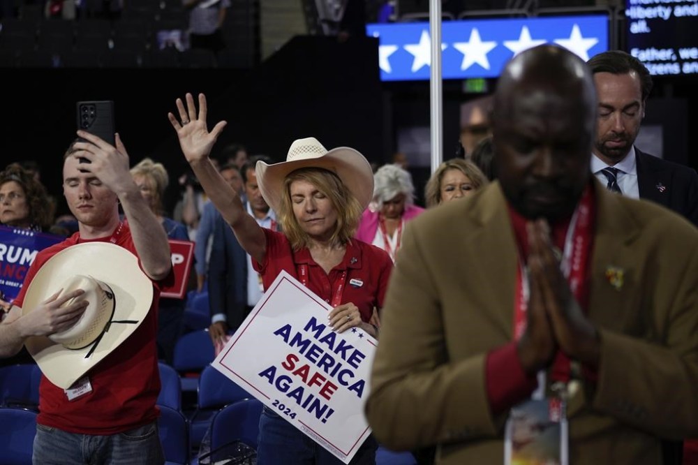 Delegates pray during the Republican National Convention, Tuesday, July 16, 2024, in Milwaukee. (AP Photo/Jae C. Hong)