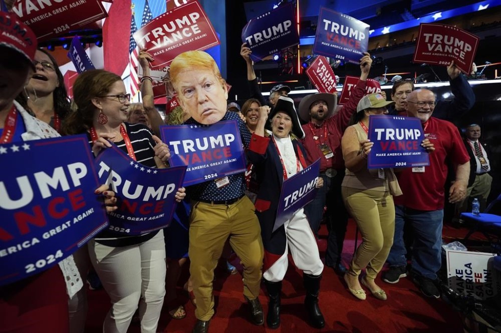 Delegates dance around during the Republican National Convention, Tuesday, July 16, 2024, in Milwaukee. (AP Photo/Paul Sancya)