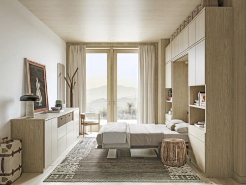 This image provided by California Closets shows a comfortable and cozy sleeping area in a studio apartment. Murphy beds – wall beds that can be tucked up into their own frame with accompanying storage – can be great space savers. (California Closets via AP)