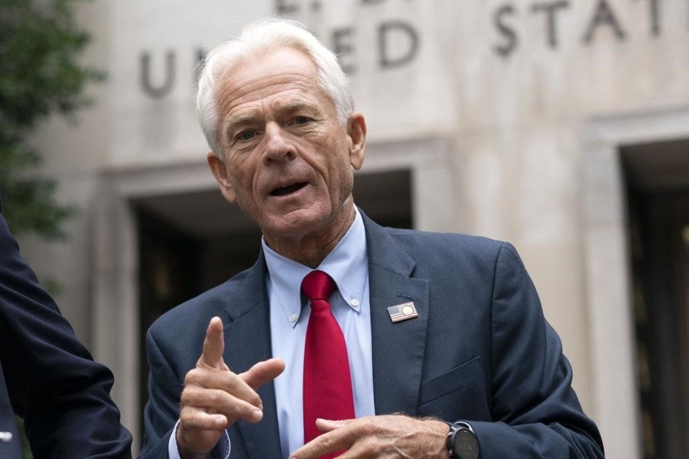 FILE - Former Trump White House advisor Peter Navarro speaks to the media as he leaves federal court in Washington, Aug. 11, 2022. Navarro has been released from prison in Florida after completing his sentence for a contempt of Congress conviction and is expected to speak hours later at the Republican National Convention in Milwaukee. The federal Bureau of Prisons says Navarro was released Wednesday after serving four months for refusing to cooperate with a congressional investigation into the Jan. 6, 2021, attack on the U.S. (AP Photo/Jose Luis Magana)