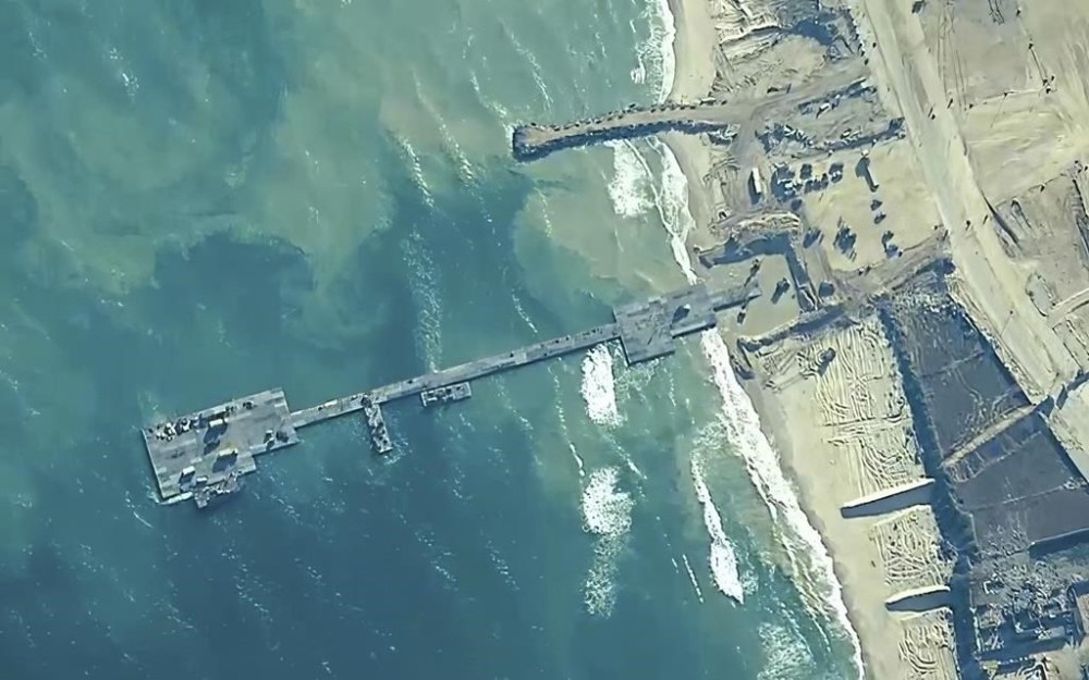 FILE - The image provided by U.S, Central Command, shows U.S. Army soldiers assigned to the 7th Transportation Brigade (Expeditionary), U.S. Navy sailors assigned to Amphibious Construction Battalion 1, and Israel Defense Forces placing the Trident Pier on the coast of Gaza Strip on May 16, 2024. The U.S. military-built pier to carry humanitarian aid to Gaza is being dismantled and brought home, ending a mission that has been fraught with weather and security problems. (U.S. Central Command via AP)