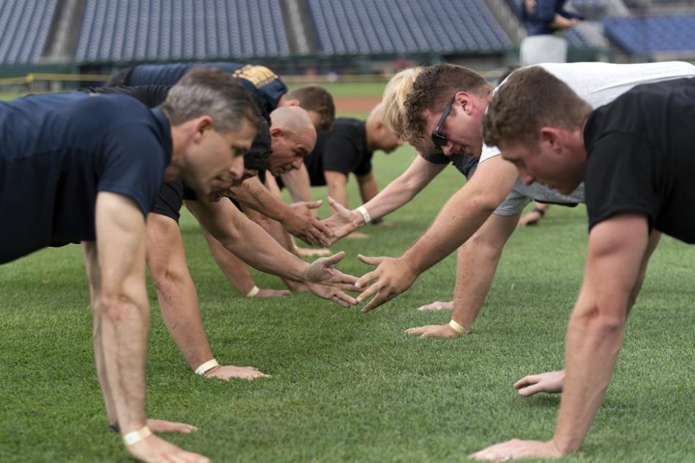 Military service members workout during the high intensity interval training for members of the military at Nationals Park, Tuesday, July 16, 2024 in Washington. ( AP Photo/Jose Luis Magana)