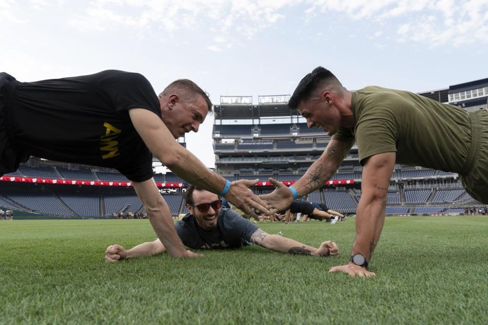 Military service members workout during the high intensity interval training for members of the military at Nationals Park, Tuesday, July 16, 2024 in Washington. ( AP Photo/Jose Luis Magana)