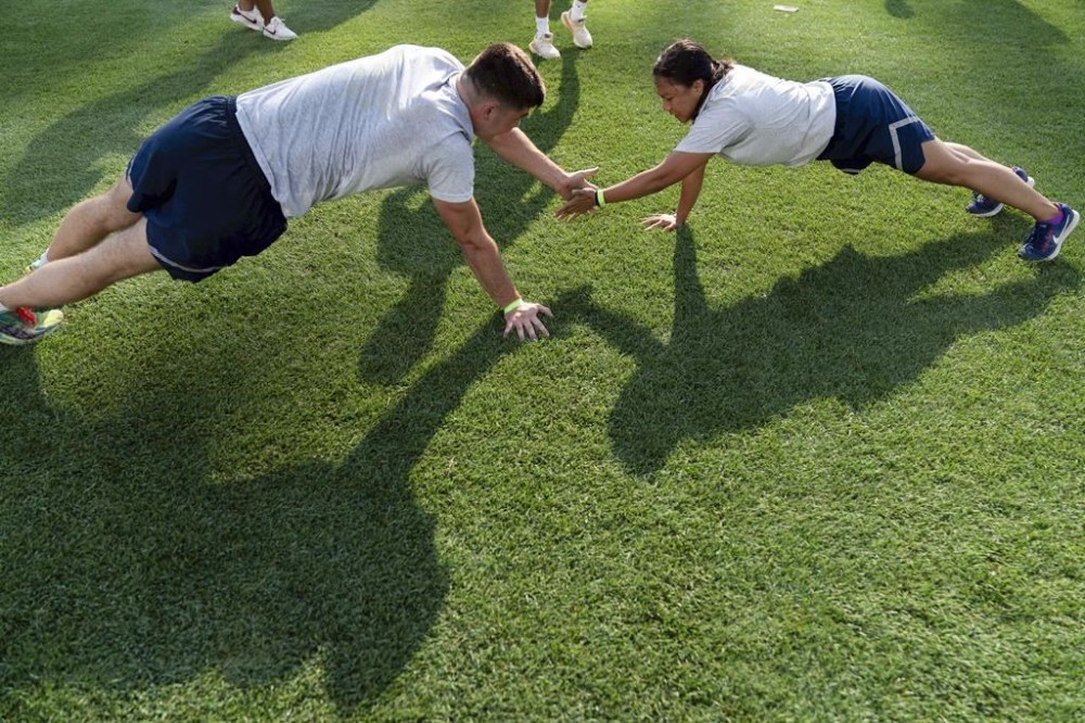 Military service members workout during the high intensity interval training for members of the military at Nationals Park, Tuesday, July 16, 2024 in Washington. ( AP Photo/Jose Luis Magana)