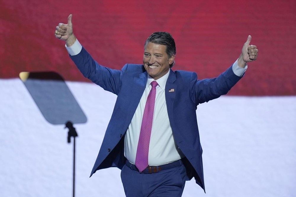 Rep. Ronny Jackson, R-Texas, raises his arms while on stage during the Republican National Convention Wednesday, July 17, 2024, in Milwaukee. (AP Photo/J. Scott Applewhite)