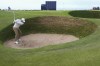 Rory McIlroy of Northern Ireland plays out of a bunker on the 17th during a practice round ahead of the British Open Golf Championships at Royal Troon golf club in Troon, Scotland, Wednesday, July 17, 2024. (AP Photo/Jon Super)