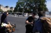 A police officer checks people at the security perimeter set up for the Olympic Games, outside Notre Dame cathedral, Thursday, July 18, 2024 in Paris. Starting Thursday, parts of the French capital will only be accessible to people who have registered for a QR code, as part of the massive security operation ahead of the Paris 2024 Olympic Games. (AP Photo/David Goldman)