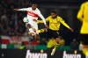 FILE - Stuttgart's Serhou Guirassy, left, vies for the ball with Dortmund's Youssoufa Moukoko, during the German Soccer Cup round of 16 match between VfB Stuttgart and Borussia Dortmund, at Stuttgart, Germany, on Dec. 6, 2023. Borussia Dortmund has finally completed the signing of Guinea forward Serhou Guirassy from Bundesliga rival Stuttgart after an injury-related delay. Guirassy’s expected transfer was delayed after a medical examination revealed an injury sustained while playing for Guinea at the end of last season. Dortmund says the injury will “not require an operation” and that “medical personnel expect him to be available later in the summer.” (Tom Weller/dpa via AP)