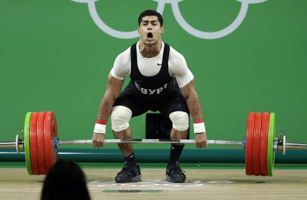 FILE - Mohamed Mahmoud, of Egypt, competes during the men's 77kg weightlifting competition at the 2016 Summer Olympics in Rio de Janeiro, Brazil, Wednesday, Aug. 10, 2016. Weightlifters Mohamed Mahmoud of Egypt and Alexandr Spac of Moldova have returned adverse analytical findings from re-tests of samples from the 2016 Rio Olympics, according to the International Testing Agency, announced this week. (AP Photo/Mike Groll, File)