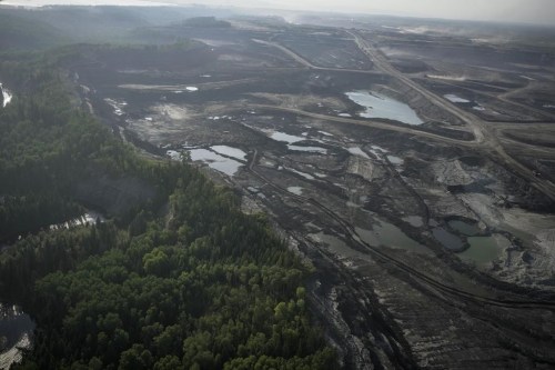 The oil and gas sector, like all industries, is exposed to climate risk from events like fires and extreme weather. Trees line Suncor's oilsands operation near Fort McMurray, Alta. on Friday, Sep. 1, 2023. THE CANADIAN PRESS/AP/Victor R. Caivano