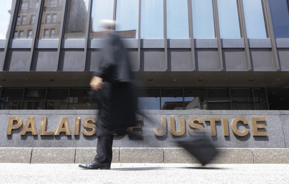 A lawyer walks past the courthouse in Montreal on July 12, 2023. THE CANADIAN PRESS/Christinne Muschi
